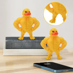 Mini Buff Duck Figurine displayed on a shelf beside a phone