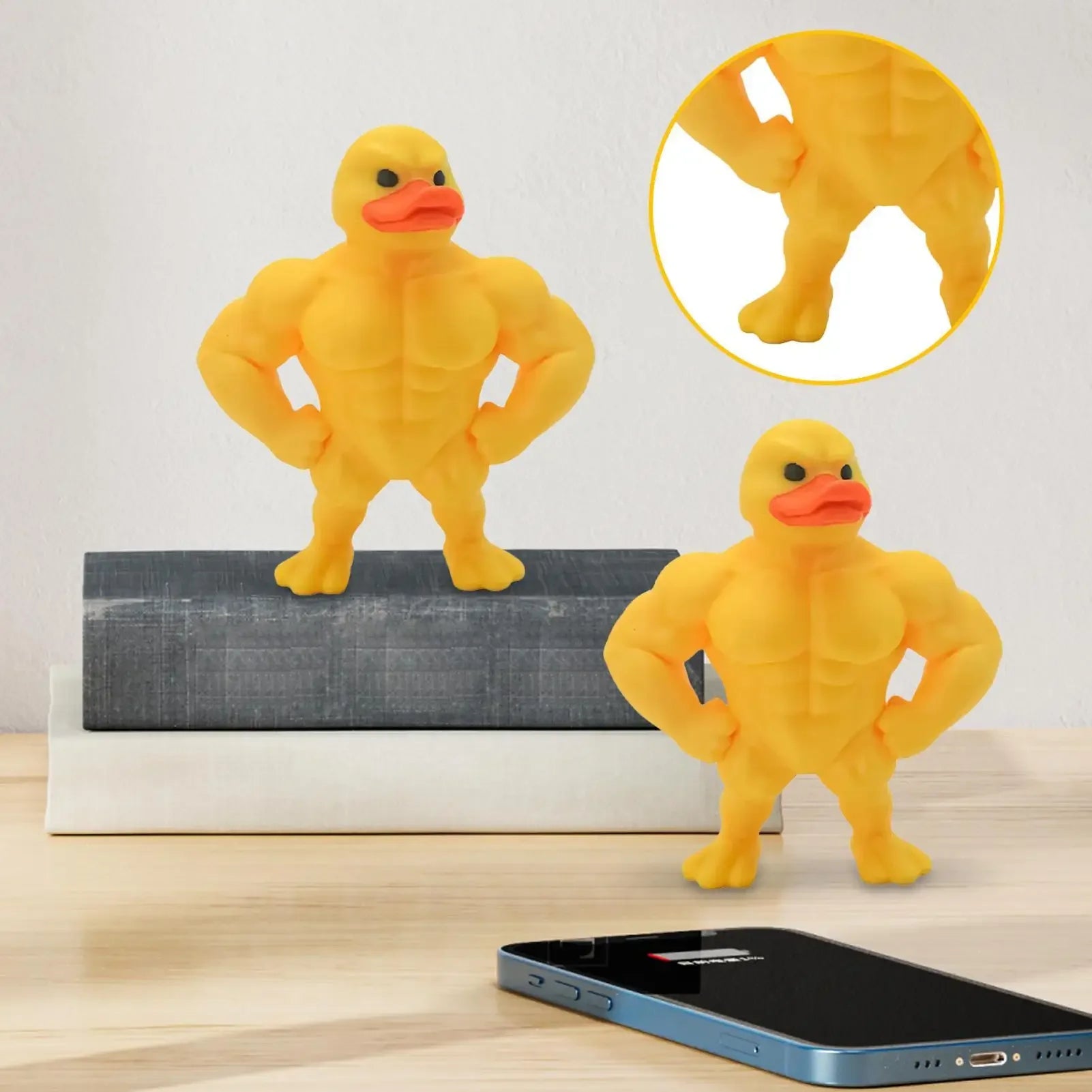 Mini Buff Duck Figurine displayed on a shelf beside a phone