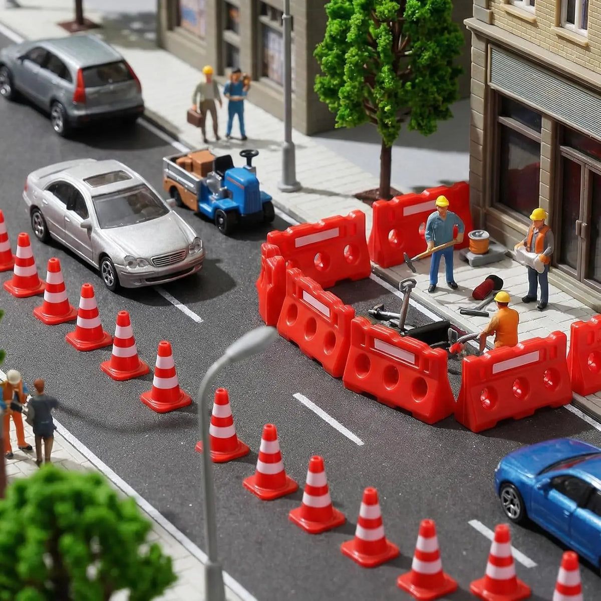 Mini Construction Zone Set cones and barricades marking roadworks beside model cars and worker figures.