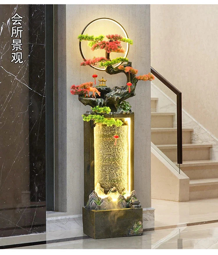 Moonlit Bonsai Waterfall in a lobby beside a staircase, pale stone flooring and a dark marble wall.