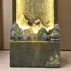 Moonlit Bonsai Waterfall close-up of sculpted mountain peaks, golden illumination and textured dark base.