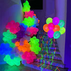 Neon Pop Party Balloons arranged along a staircase with colorful decorations under blacklight.