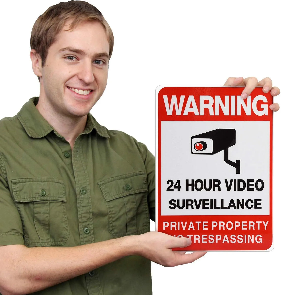 No Trespassing Security Sign held by a man, showing red warning lettering and a black surveillance camera graphic.