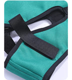 Black fastening strap across the ear opening of a green supplier-example cervical traction sling