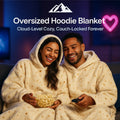 HighPeak Oversized Hoodie Blanket in cream with sherpa lining worn by couple enjoying popcorn on a couch