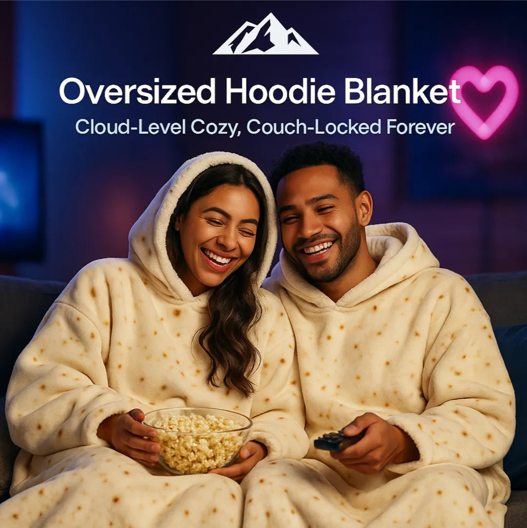 HighPeak Oversized Hoodie Blanket in cream with sherpa lining worn by couple enjoying popcorn on a couch