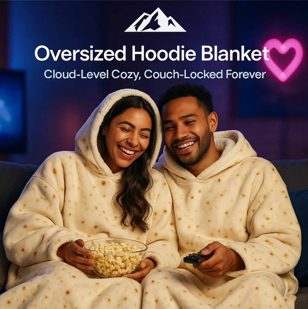 HighPeak Oversized Hoodie Blanket in cream with star patterns worn by couple cuddling on couch watching TV