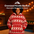 HighPeak Oversized Hoodie Blanket in red with reindeer pattern worn by smiling woman by fireplace cozy indoors