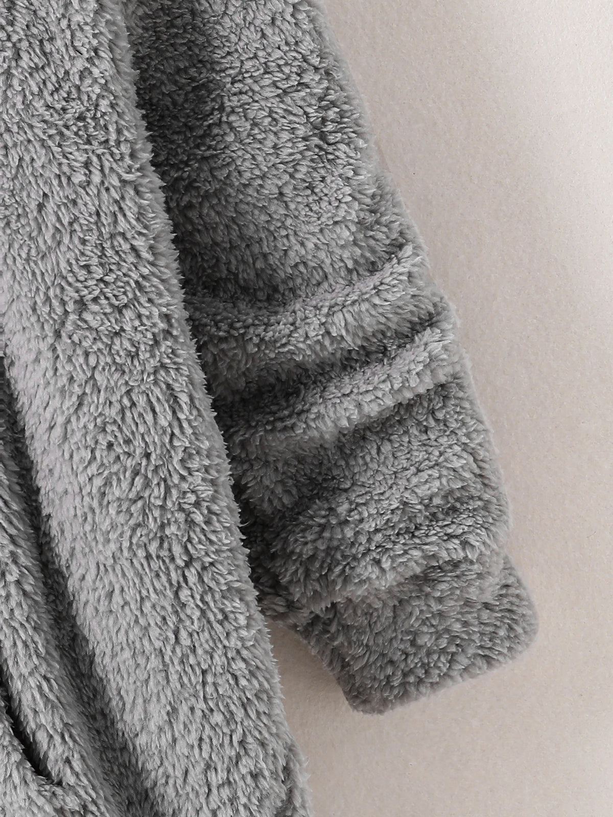 Peekaboo Cat Kids Hoodie close-up of the folded sleeve cuff and gray fluffy texture
