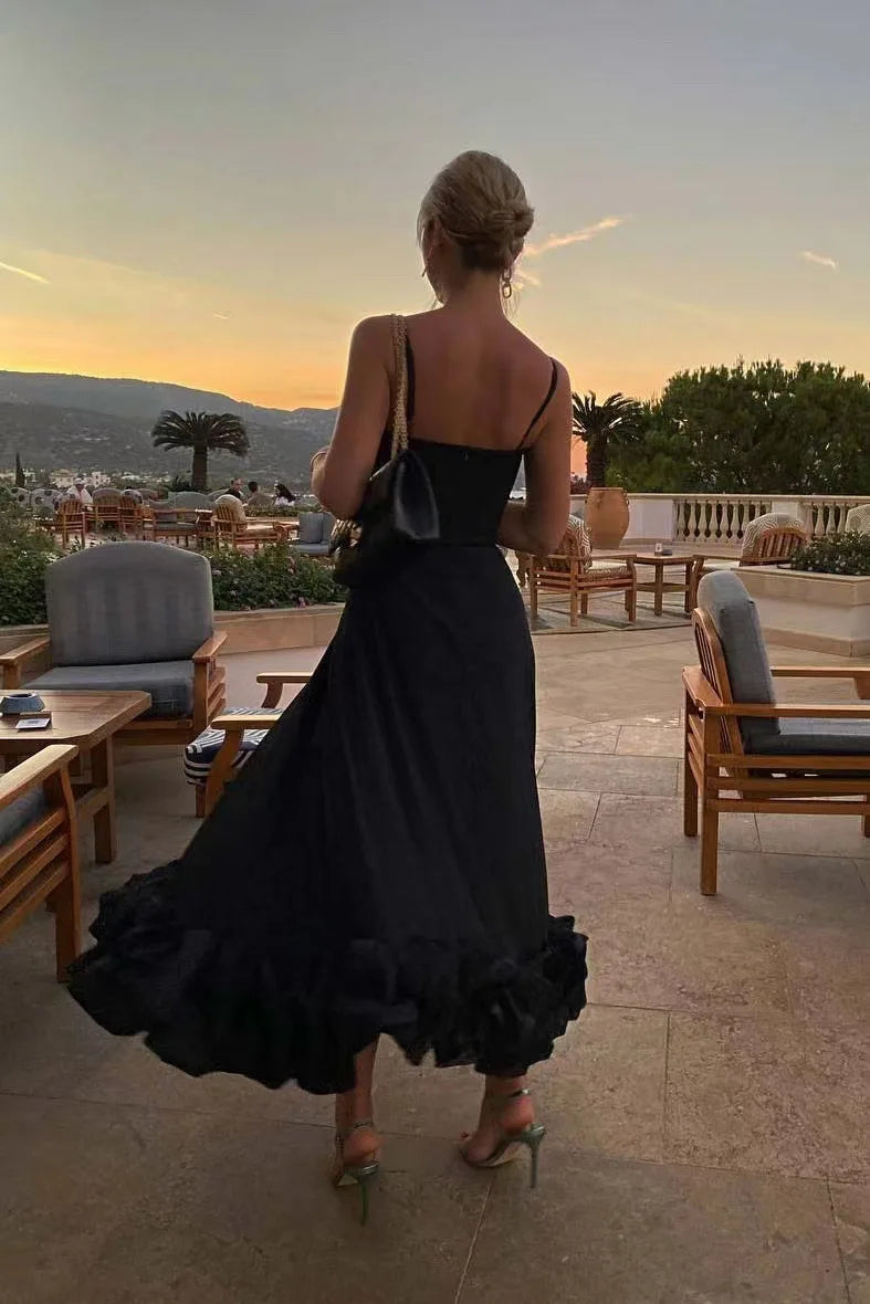 Back view of the black Petal Waltz Ruffle Dress showing thin shoulder straps and a low back