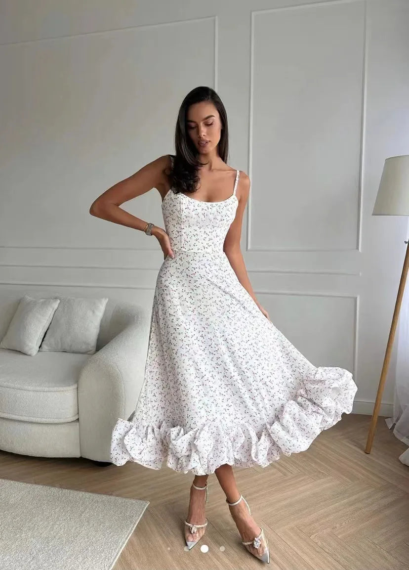 White floral-print ruffle dress with the skirt held outward; gallery style reference