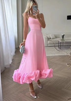 Pink Petal Waltz Ruffle Dress worn with silver heels in a mirror view