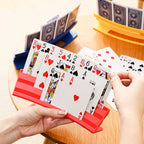 Playing Card Holder in red being used at a game table with blue and yellow holders behind it