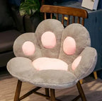 Plush Cat Paw Cushion in gray with pink paw pads fitted to a wooden chair