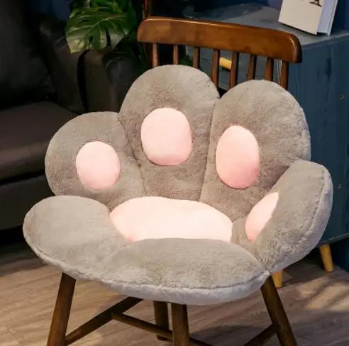 Plush Cat Paw Cushion in gray with pink paw pads fitted to a wooden chair