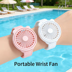 Portable Mini Wrist Fan pink and white fans worn on two wrists beside a swimming pool