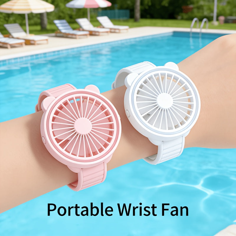 Portable Mini Wrist Fan pink and white fans worn on two wrists beside a swimming pool