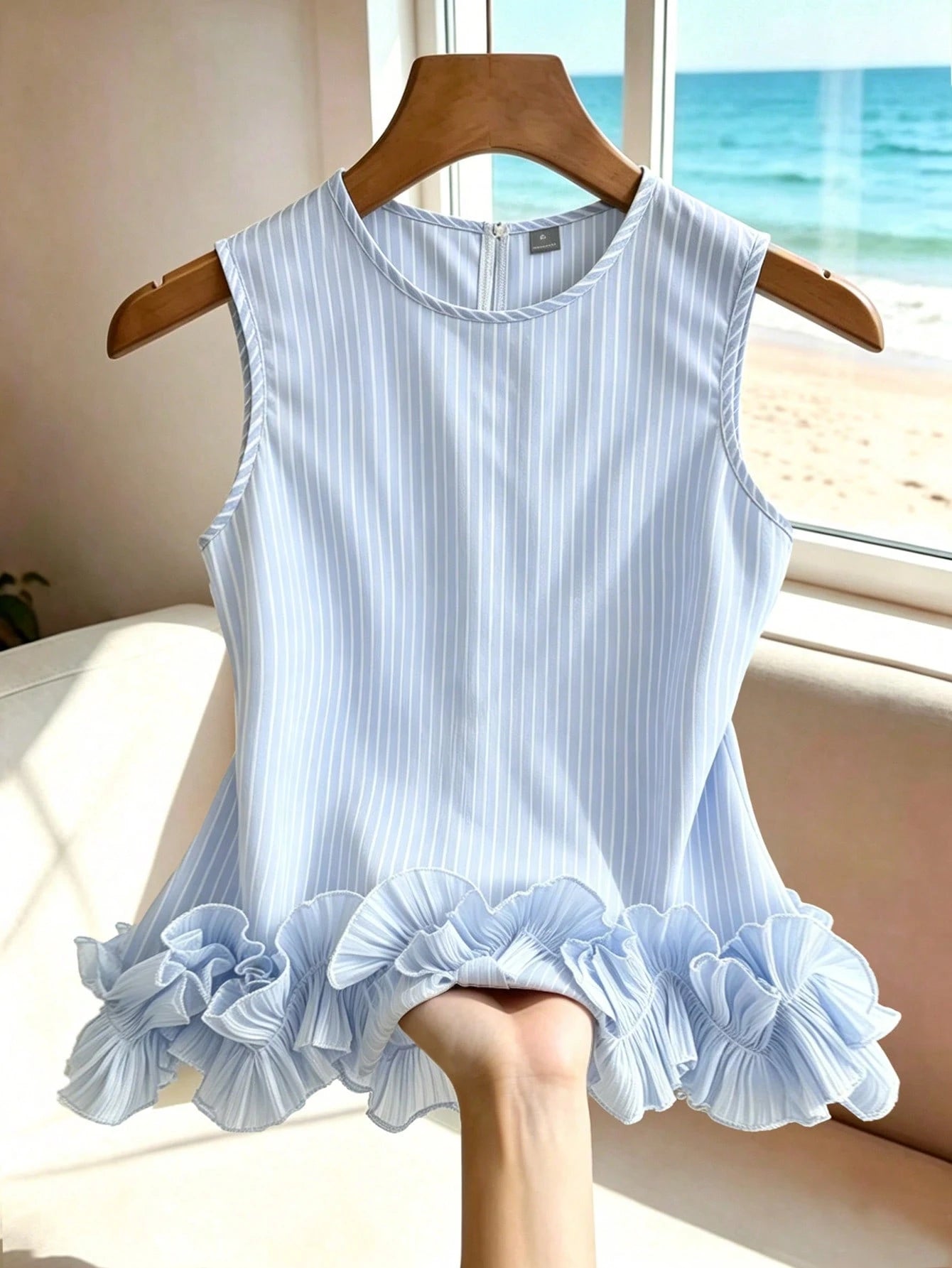 Portofino Ruffle Top front view in light blue and white stripes with a double-layered ruffle hem