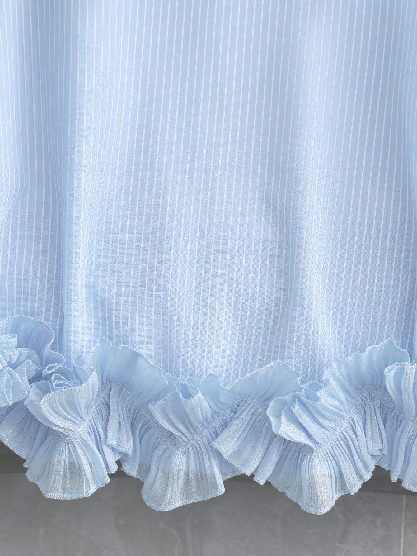 Portofino Ruffle Top detail view of the double-layered pleated ruffle hem