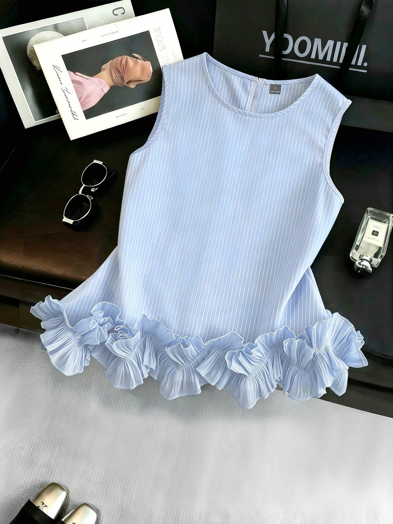 Portofino Ruffle Top front product view with blue and white stripes, sleeveless cut, and ruffle hem