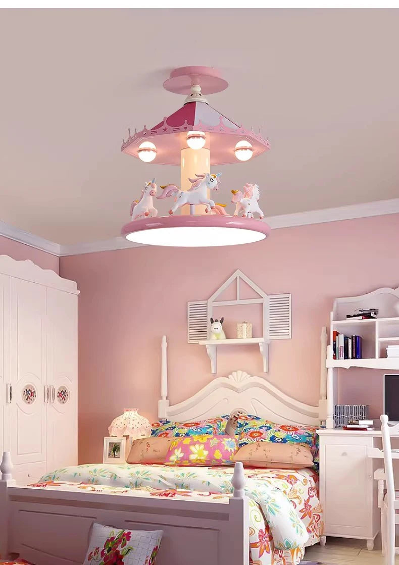 Full bedroom view showing the pink carousel lamp above floral bedding and white furniture