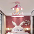 Pink unicorn carousel lamp above a bed with a floral wreath and globe bedside lights