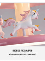 Close-up of a white winged unicorn figure with pink details and a blue horn