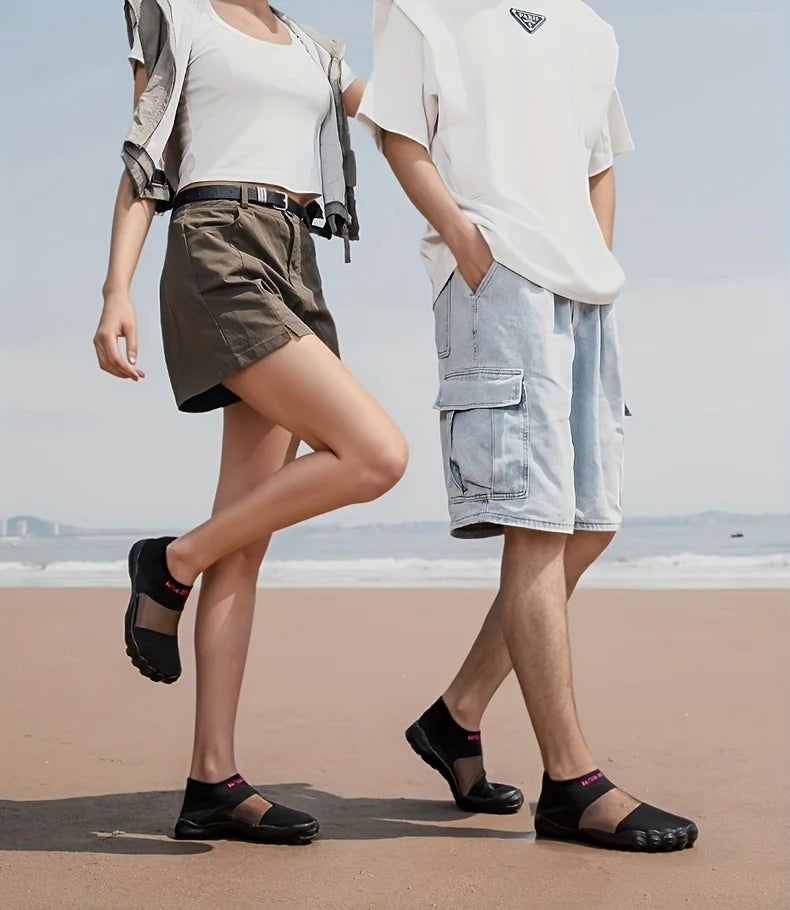 Quick-Dry Water Shoes black pairs worn by two adults standing together on a sandy beach.