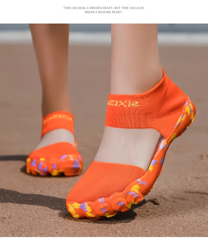 Quick-Dry Water Shoes orange pair on sand, with yellow and purple accents around the front sole.