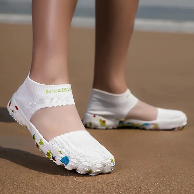 Quick-Dry Water Shoes white pair on feet at the beach, showing the sheer instep panels.
