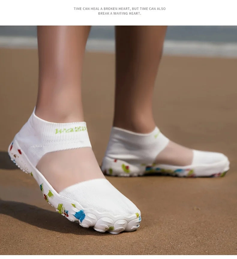 Quick-Dry Water Shoes white shoes worn on sand, with one foot angled toward the camera.