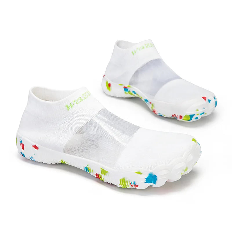 Quick-Dry Water Shoes white slip-on pair viewed diagonally with colorful rubber sole details.