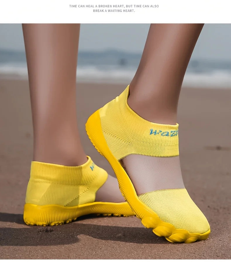 Quick-Dry Water Shoes yellow pair worn on sand, with one foot angled to show the side and toe.