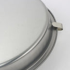 Quick Release Cake Pan underside close-up showing the curved release tab at the rim
