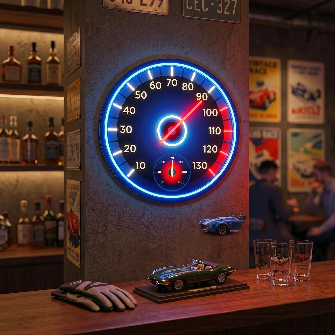 Racing Speedometer Neon Sign glowing above a home bar with model cars and driving gloves