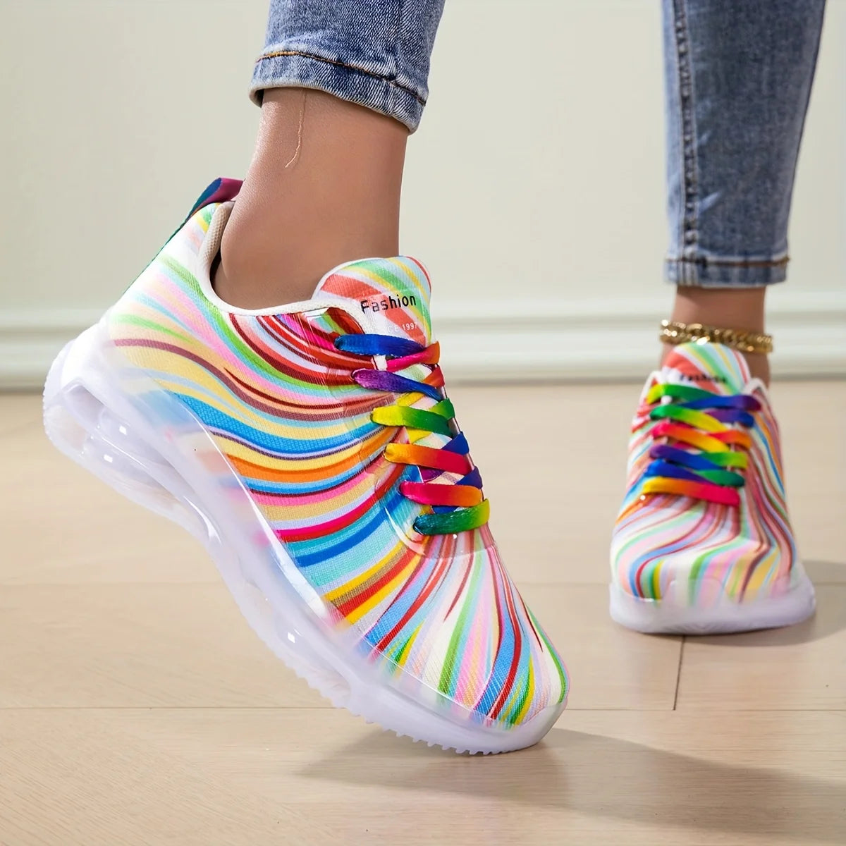Rainbow Stripe Sneakers worn with cropped jeans, showing multicolor laces and a raised white sole.