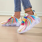 Rainbow Stripe Sneakers worn with denim, one heel raised to show the colorful upper and white sole.