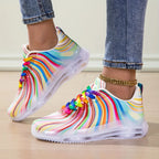 Rainbow Stripe Sneakers in side profile, with curved colorful stripes and sculpted white soles.
