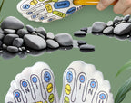 Printed reflexology sock soles and massage stick styled beside smooth zen stones