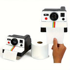 Retro Camera Toilet Paper Holder shown beside a roll with paper dispensing through the front
