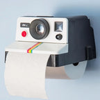 Retro Camera Toilet Paper Holder mounted with a toilet paper roll dispensing from the front