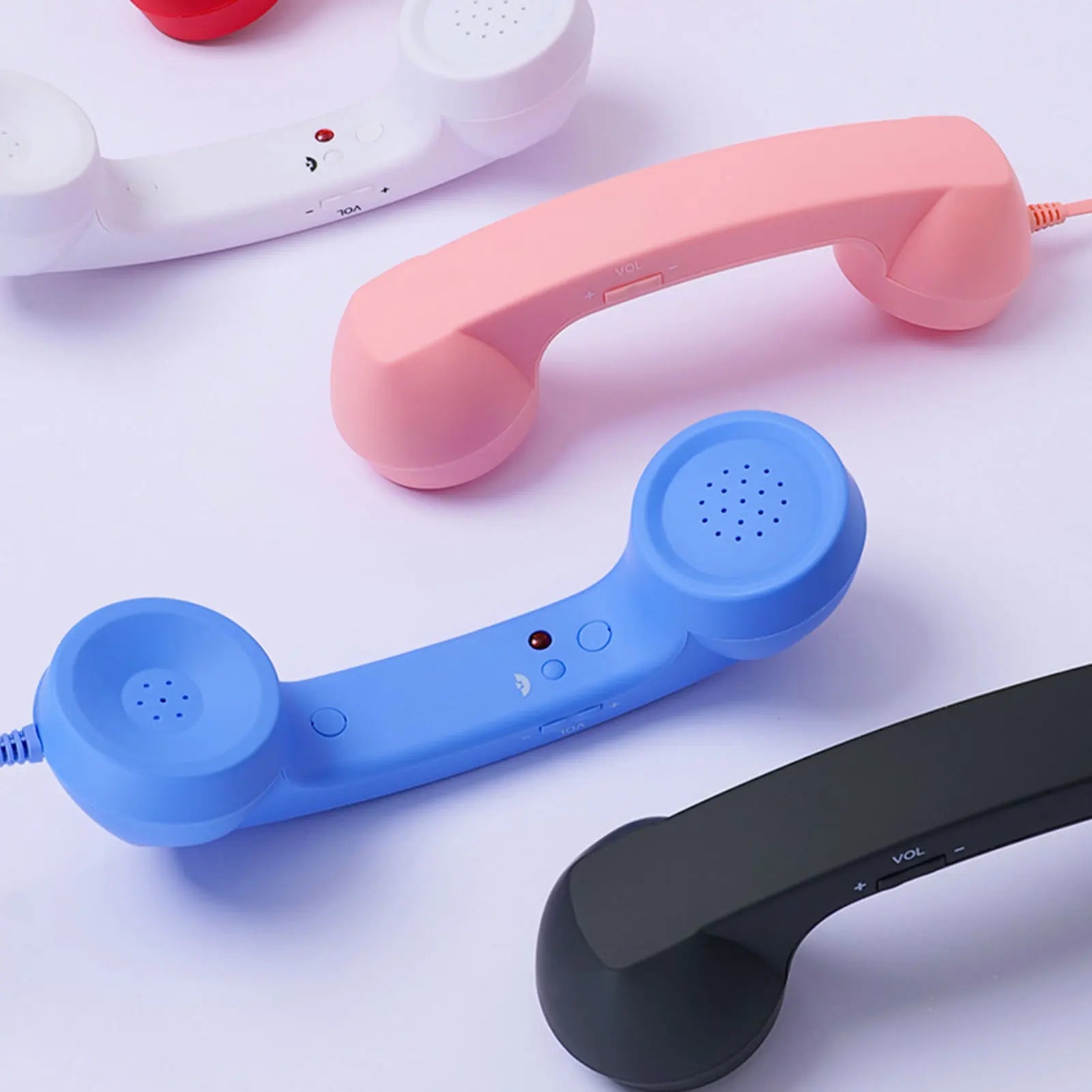 Close-up of pink, blue and black Retro Mobile Phone Handsets