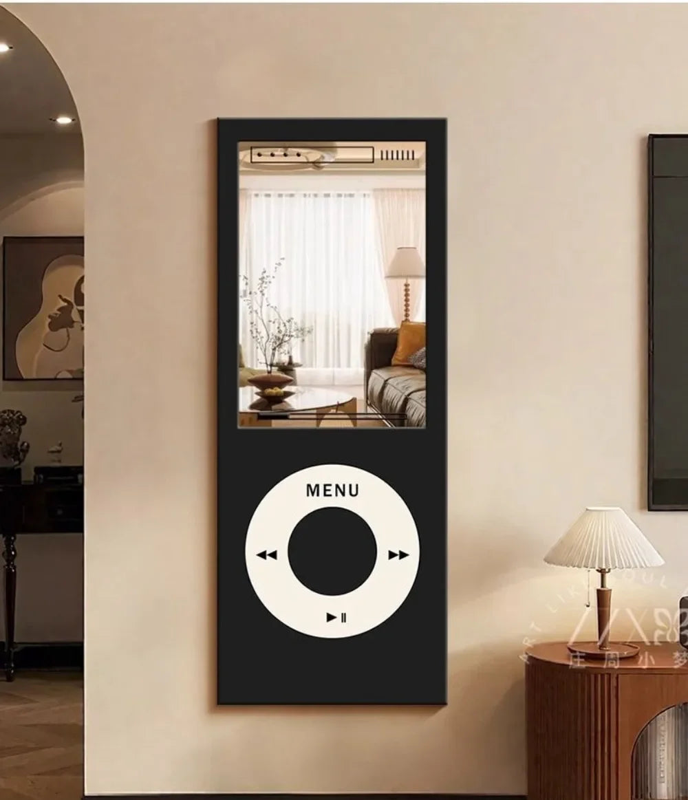 Retro MP3 Wall Mirror in black mounted vertically on a cream wall beside an arched doorway and table lamp