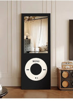Retro MP3 Wall Mirror in black shown full length against a paneled wall beside a vintage radio cabinet