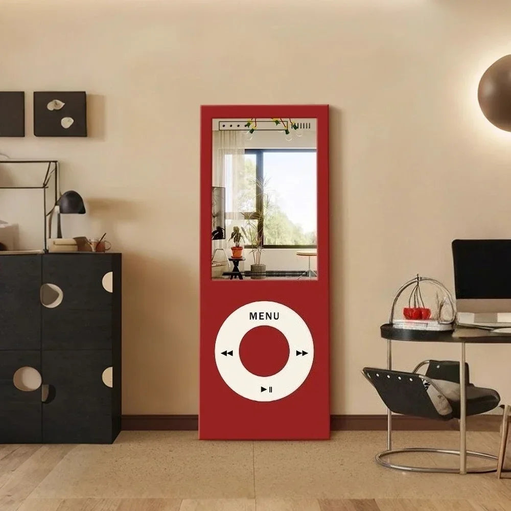 Retro MP3 Wall Mirror in red displayed upright in a modern living room with its reflective upper panel visible