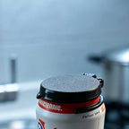 Reusable Soda Can Lid closed over a beverage can, showing the black cover and ring around the rim.