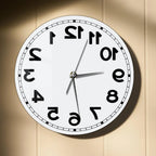 Frameless Reverse Number Wall Clock mounted on a warm neutral wall in direct light