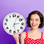 Woman holding the frameless Reverse Number Wall Clock against a purple background