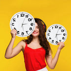 Woman holding two frameless Reverse Number Wall Clocks for visual size comparison