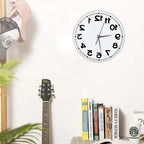 Frameless Reverse Number Wall Clock displayed above a guitar and books